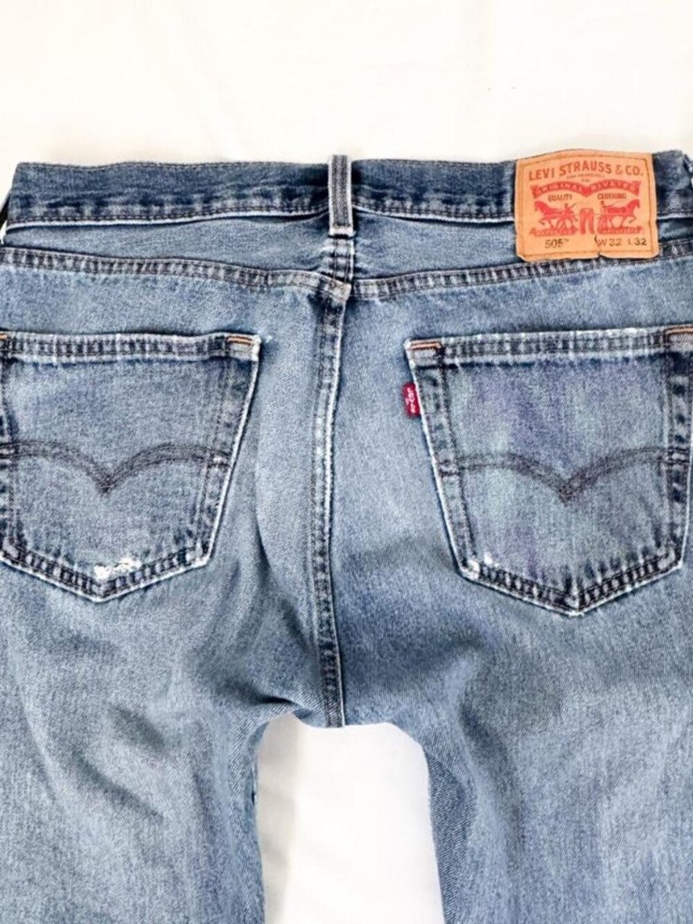Vintage Levi's distressed 505 blue jeans with a straight leg fit